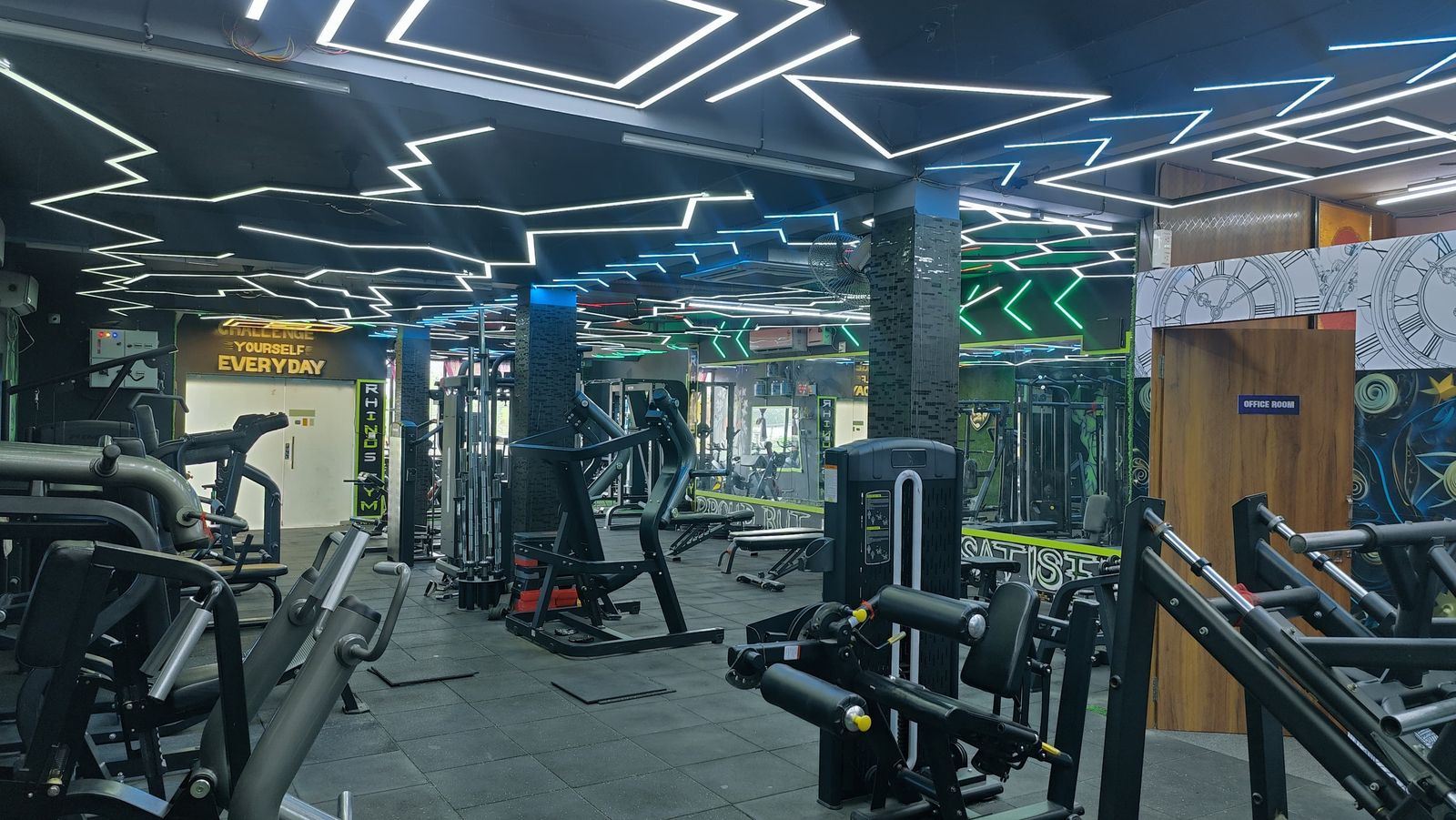 Rhinos Gym training floor in Jatani under hexagonal neon ceiling lights